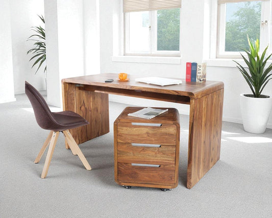 Wooden desk with chair in a bright room with plants