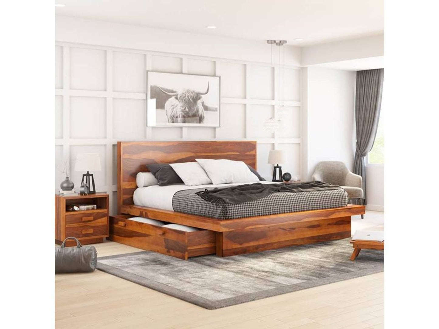 A king size Sheesham wood bed with a storage drawer, displayed in a room with a modern aesthetic, including a black and white bedside table, a grey rug, and a white wall in the background.