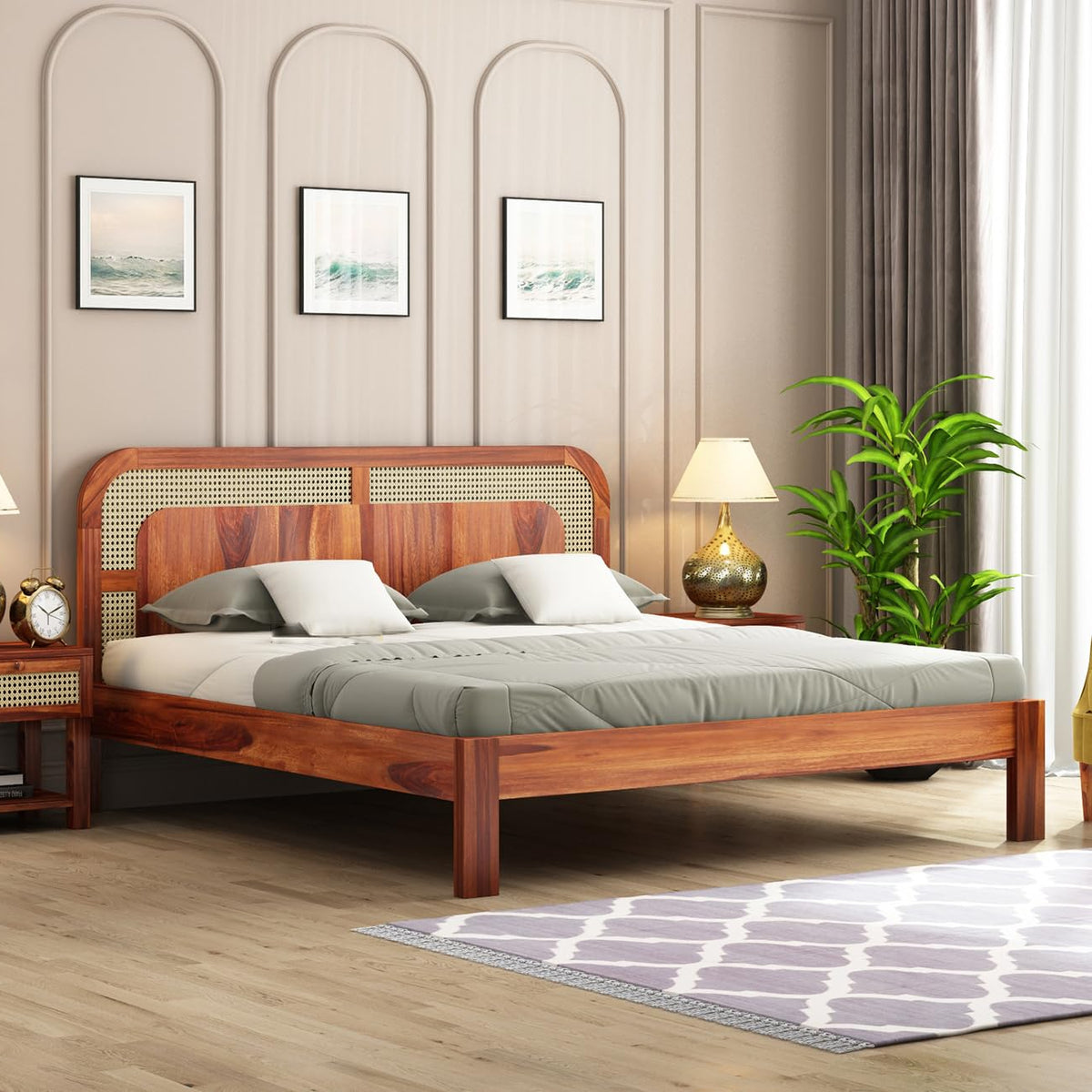A king-size Sheesham wood bed with a neutral teak finish and rattan cane design headboard, placed in a bedroom setting with decorative bedside tables and a lamp.