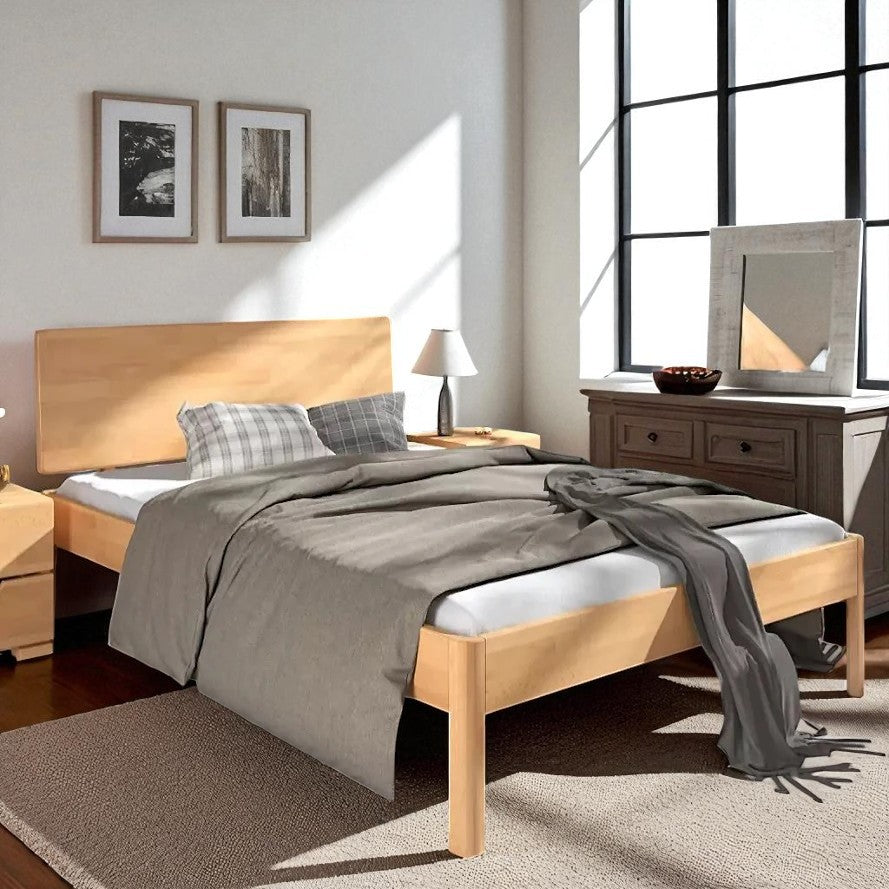 Wooden bed with gray bedding in a well-lit bedroom