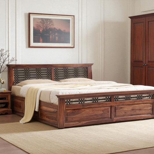 Wooden bed in a bedroom with a painting on the wall and a wardrobe.